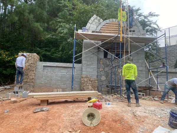 Crew setting a stone arch