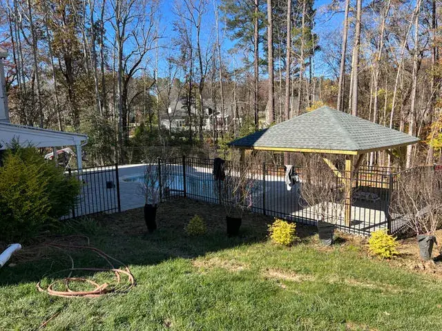 Gazebo and pool enclosure in a finished back yard